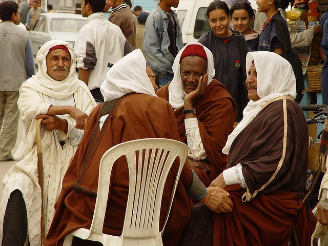 En gjeng med arabere som sitter ute i monobloc-stoler.